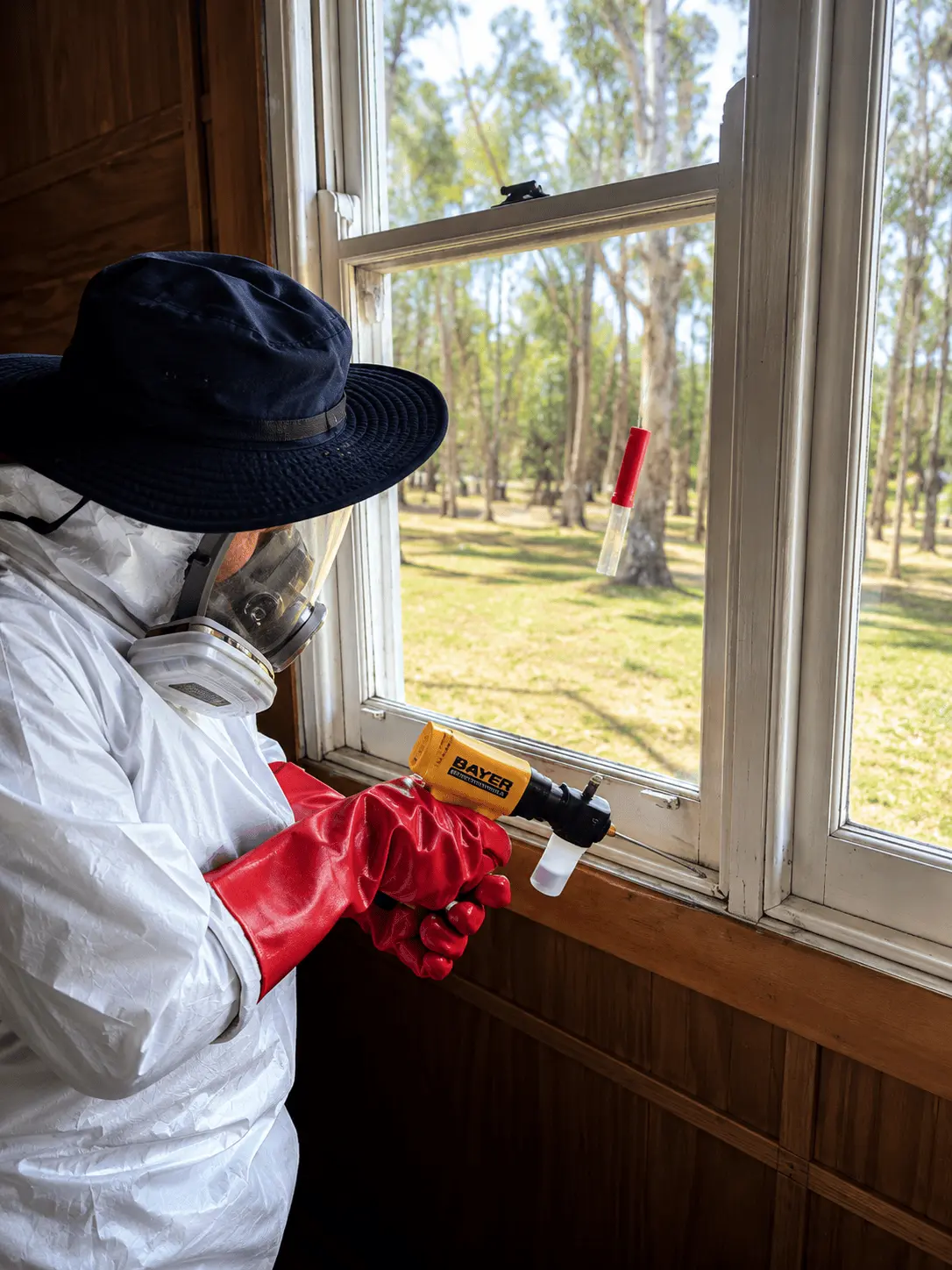 KKI Pest Control technician treating a window frame