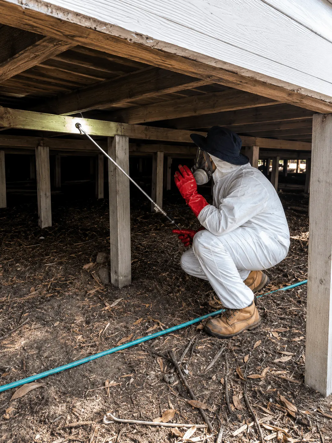 KKI Pest Control technician treating a subfloor